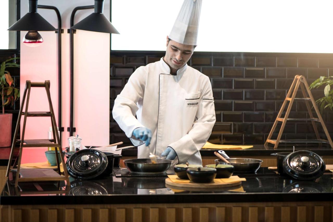 Radisson Blu Hotel, Beirut Verdun Exterior photo A chef preparing food